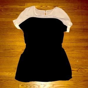 Black and white polyester and spandex dress. Size medium.With pockets.Above knee